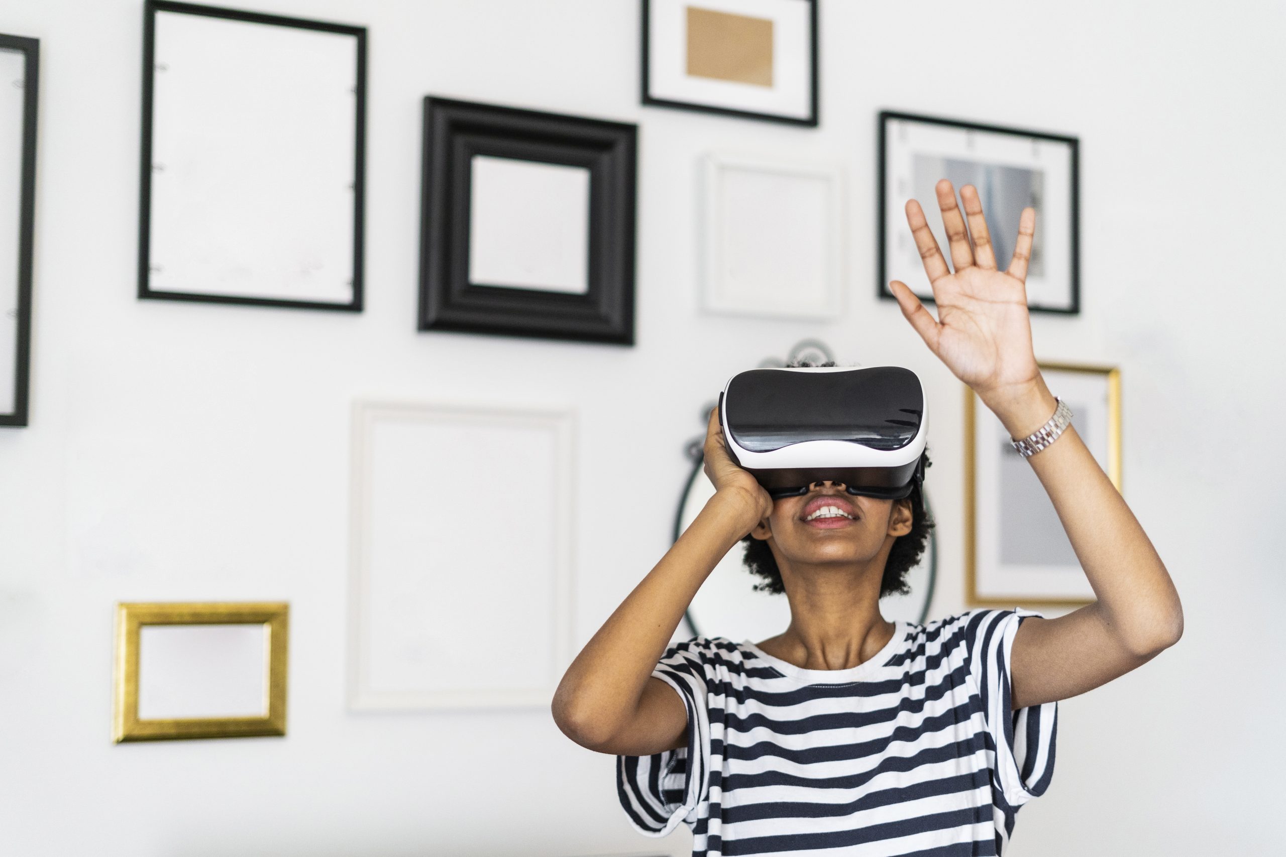 Young woman with VR glasses at home